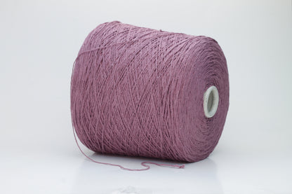 Close-up image of the burgundy silk bourette yarn, showcasing a dense ply twist and subtle sheen. The yarn appears incredibly soft and fluffy with rich color depth.