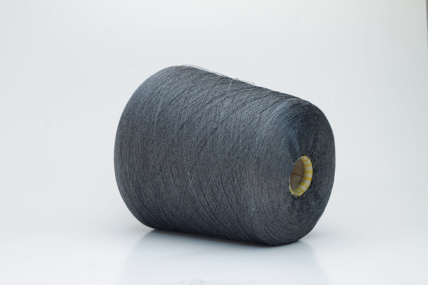 Close-up of a finely spun, lustrous dark gray silk yarn, exhibiting a smooth surface and a subtle sheen. The tightly twisted plies are visible, creating a refined, consistent thread structure.