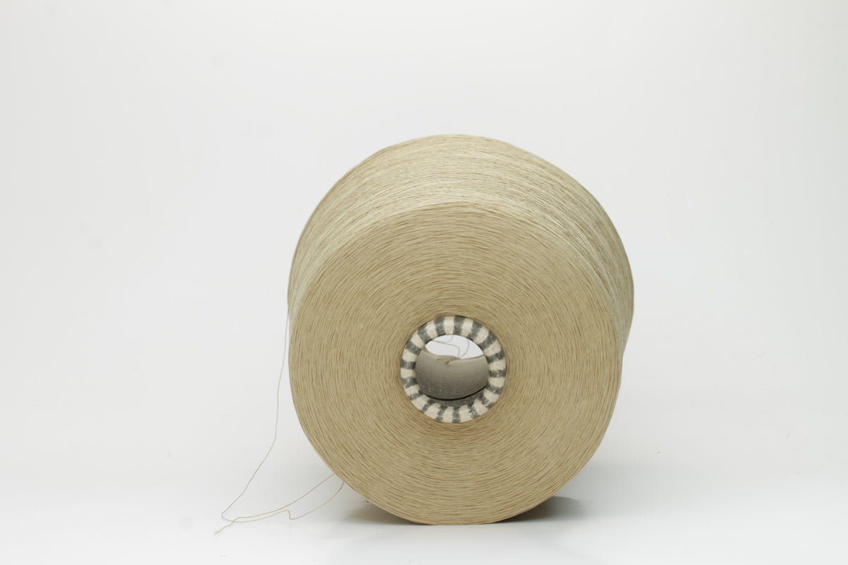 Close-up of finely spun Khaki Beige Heather 100% cotton yarn, exhibiting a soft, matte sheen and a gentle two-ply twist. The sophisticated blend of khaki and beige fibers creates a nuanced, earthy tone.