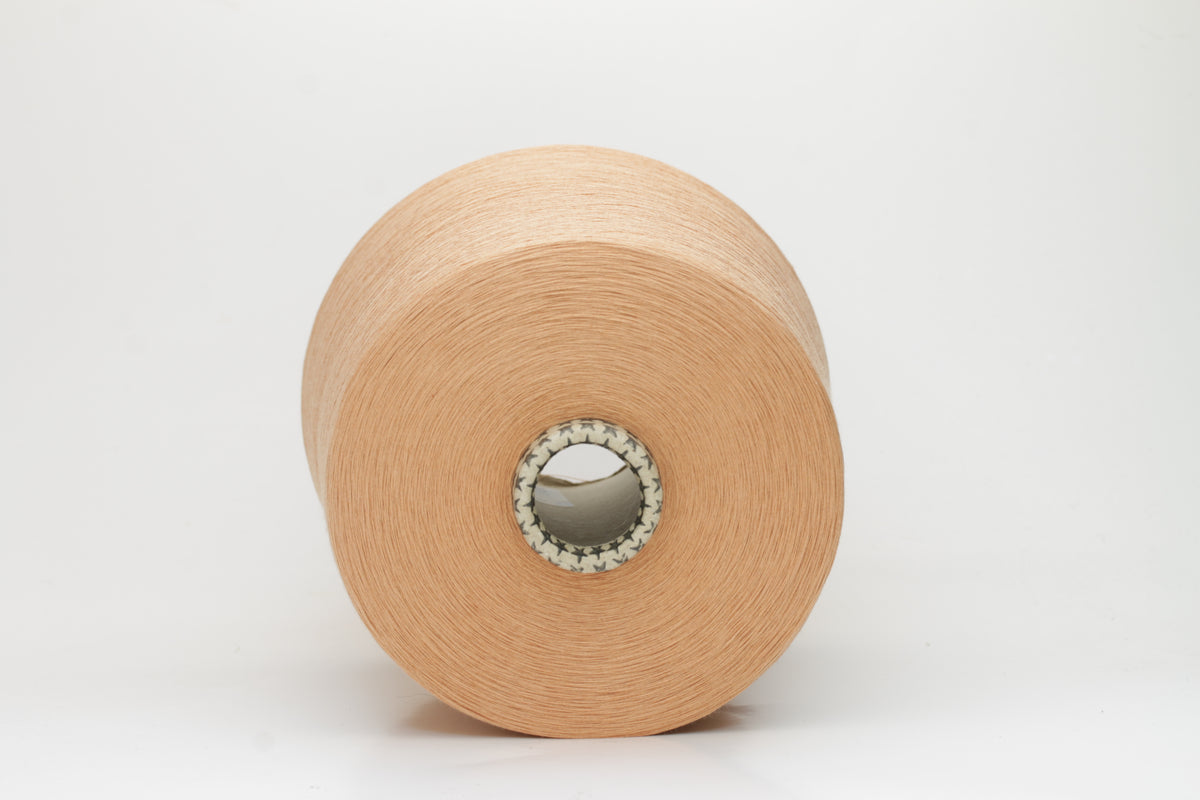 Close-up of finely spun Warm Peach Beige 100% cotton yarn, exhibiting a soft, matte sheen and a gentle two-ply twist. The sophisticated blend of khaki and beige fibers creates a nuanced, earthy tone.