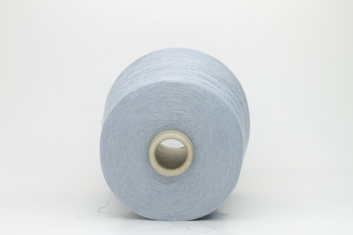 Close-up of pale frost blue 100% cotton yarn, exhibiting a tightly spun 4-ply structure with a soft, uniform sheen and smooth texture.