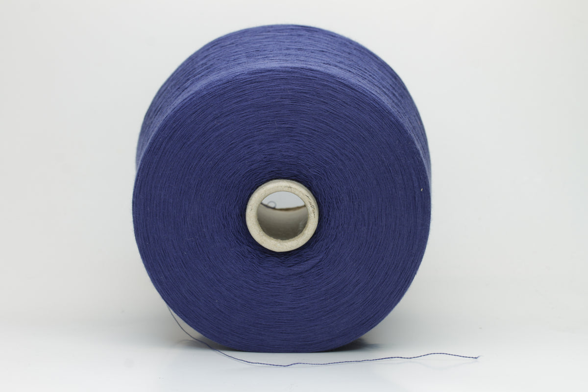 Finely twisted 2-ply cotton yarn in a rich, deep cornflower blue shade, showing a smooth, even texture and subtle natural sheen.