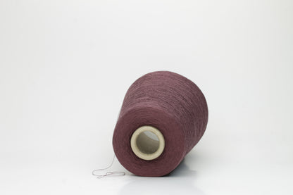 A finely spun, smooth cotton yarn, tightly plied, showcasing a muted, elegant dusty violet taupe color with a subtle matte sheen. No visible fluff.