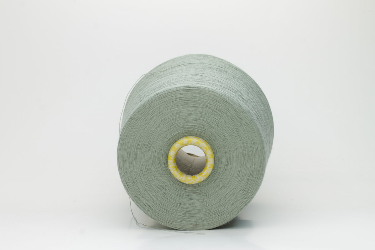 Close-up of a finely twisted Nm 2/50 cotton yarn in a muted, sophisticated sage green heather, exhibiting a subtle matte sheen and uniform ply.