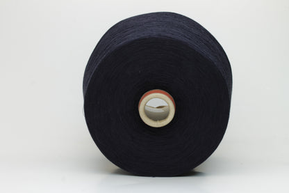A skein of finely spun, smooth 100% cotton yarn in a deep Midnight Navy, showing a subtle sheen and even, uniform twist.