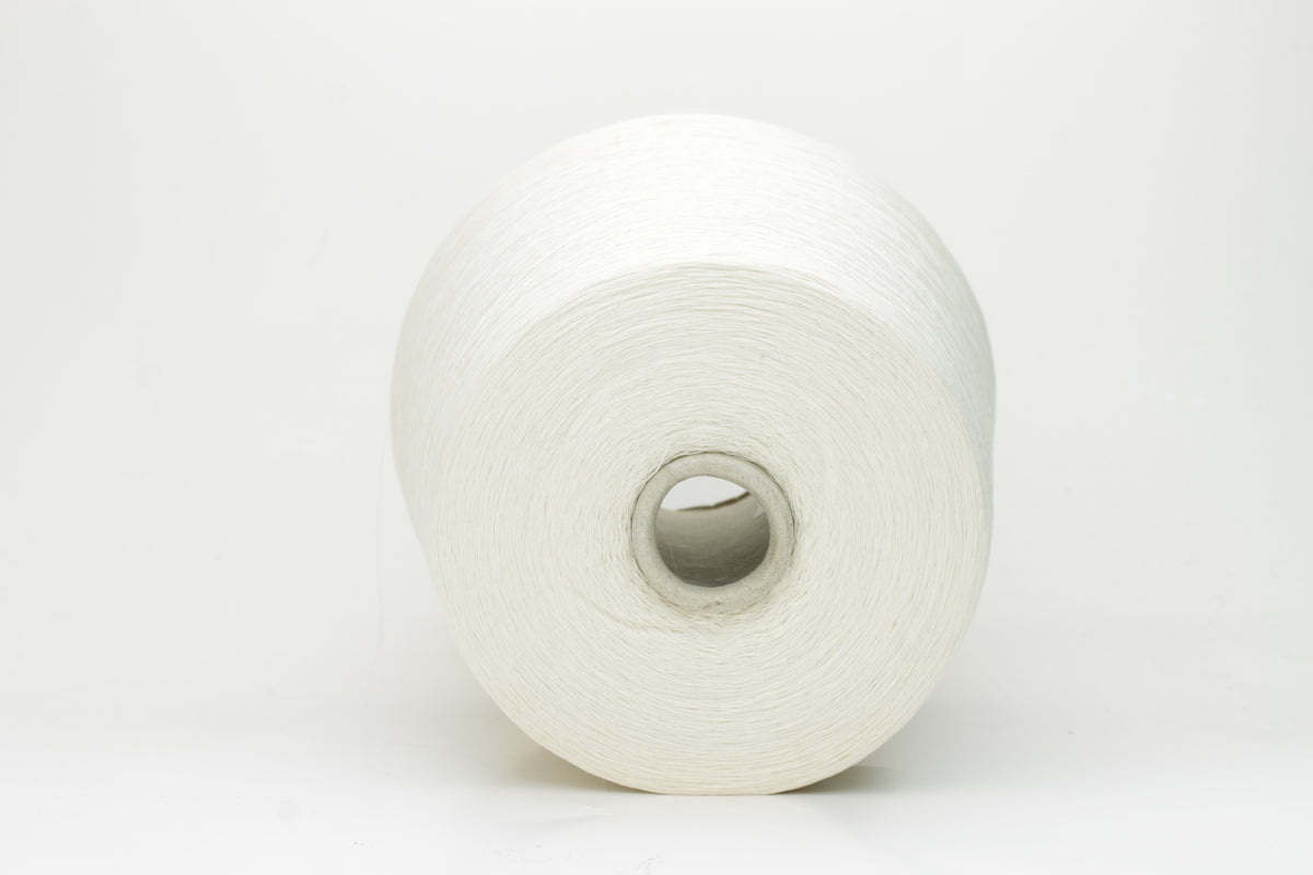 Close-up of pristine white, two-ply cotton yarn, tightly twisted with a subtle matte sheen. Smooth, uniform texture showcasing fine individual fibers.