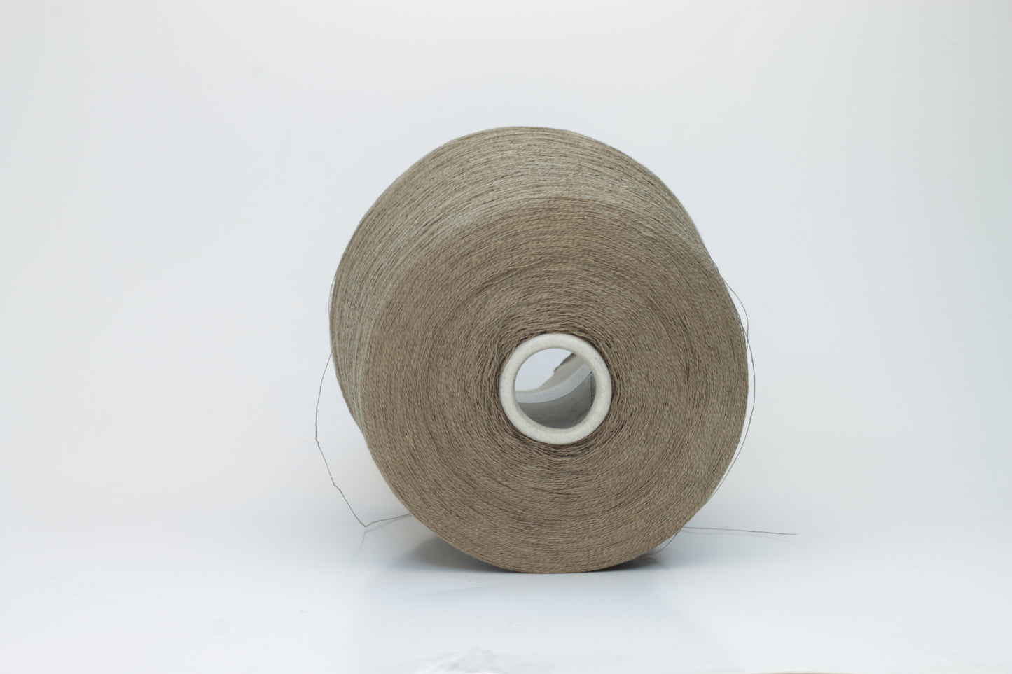 A single-ply yarn in a rich, warm 'Castoro' earthy brown. It has a slightly textured, natural linen look with a subtle sheen, wound loosely.