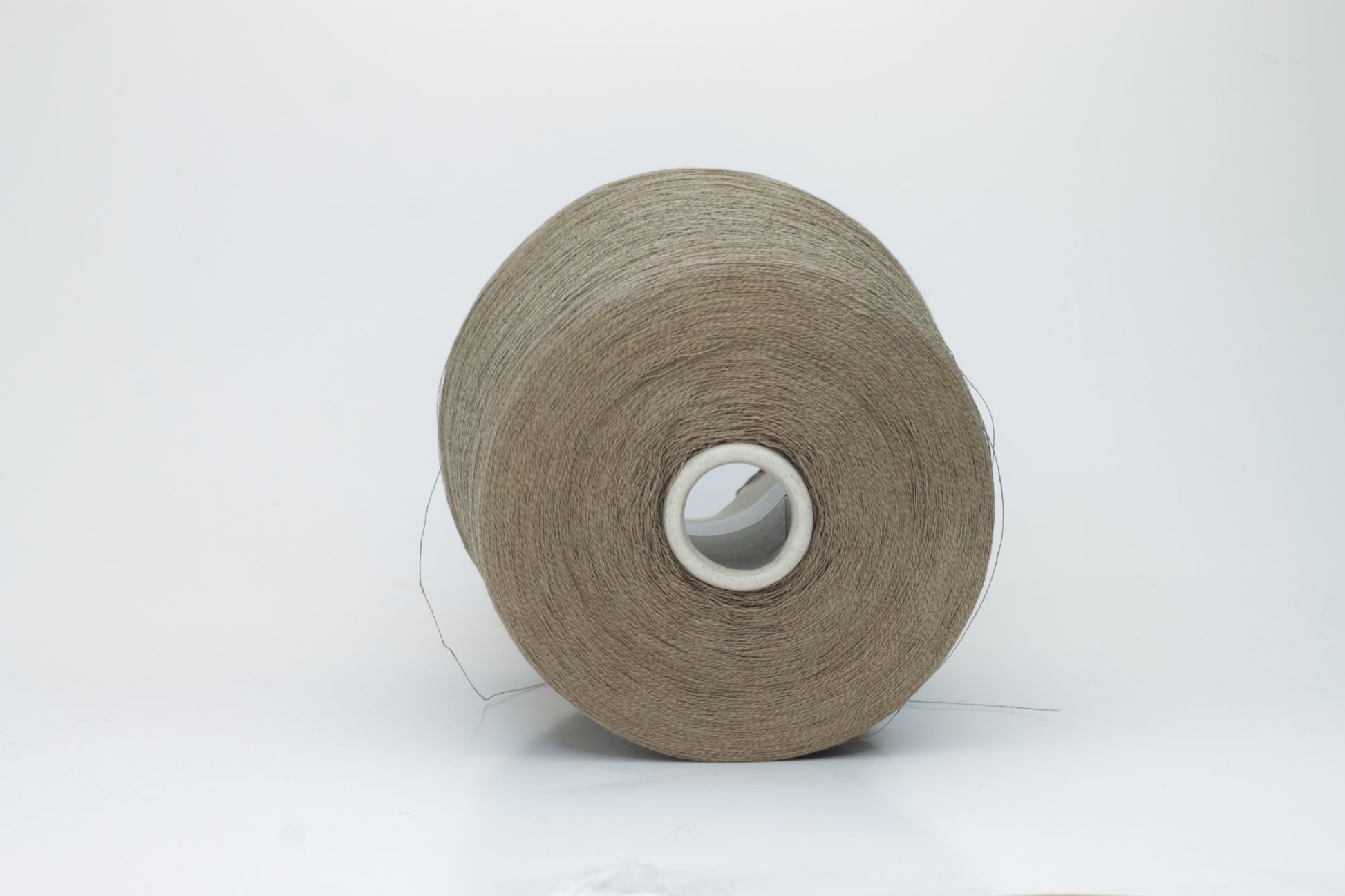 A single-ply yarn in a rich, warm 'Castoro' earthy brown. It has a slightly textured, natural linen look with a subtle sheen, wound loosely.