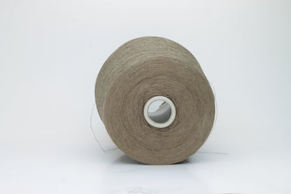 A single-ply yarn in a rich, warm 'Castoro' earthy brown. It has a slightly textured, natural linen look with a subtle sheen, wound loosely.