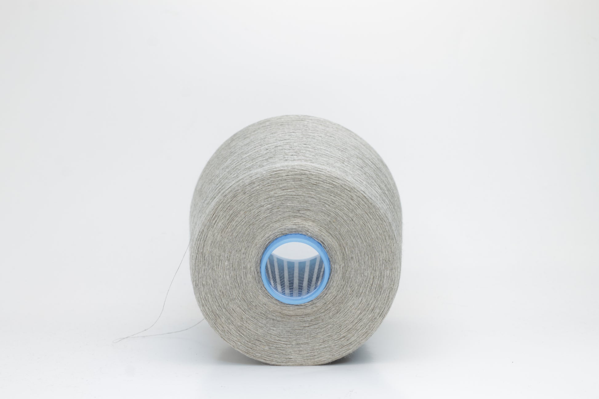 Fine, single-ply linen yarn in a Natural. Reveals a crisp texture and subtle natural sheen, typical of pure linen fiber.