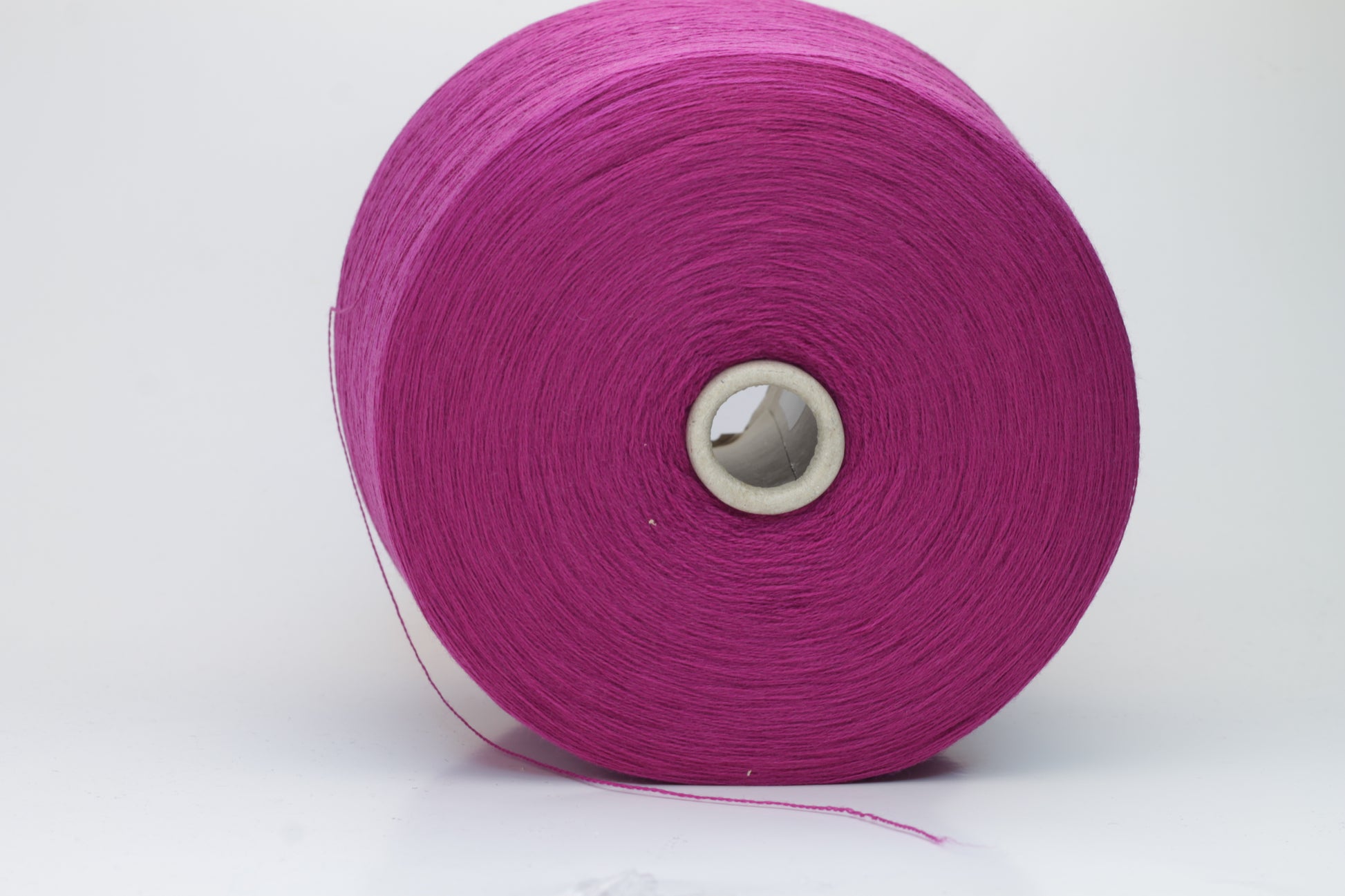 Close-up studio shot showcasing the rich purple color of Zegna Baruffa Merino Cashwool yarn. The yarn features a dense, twisted ply construction with a subtle sheen and inviting fluffiness.