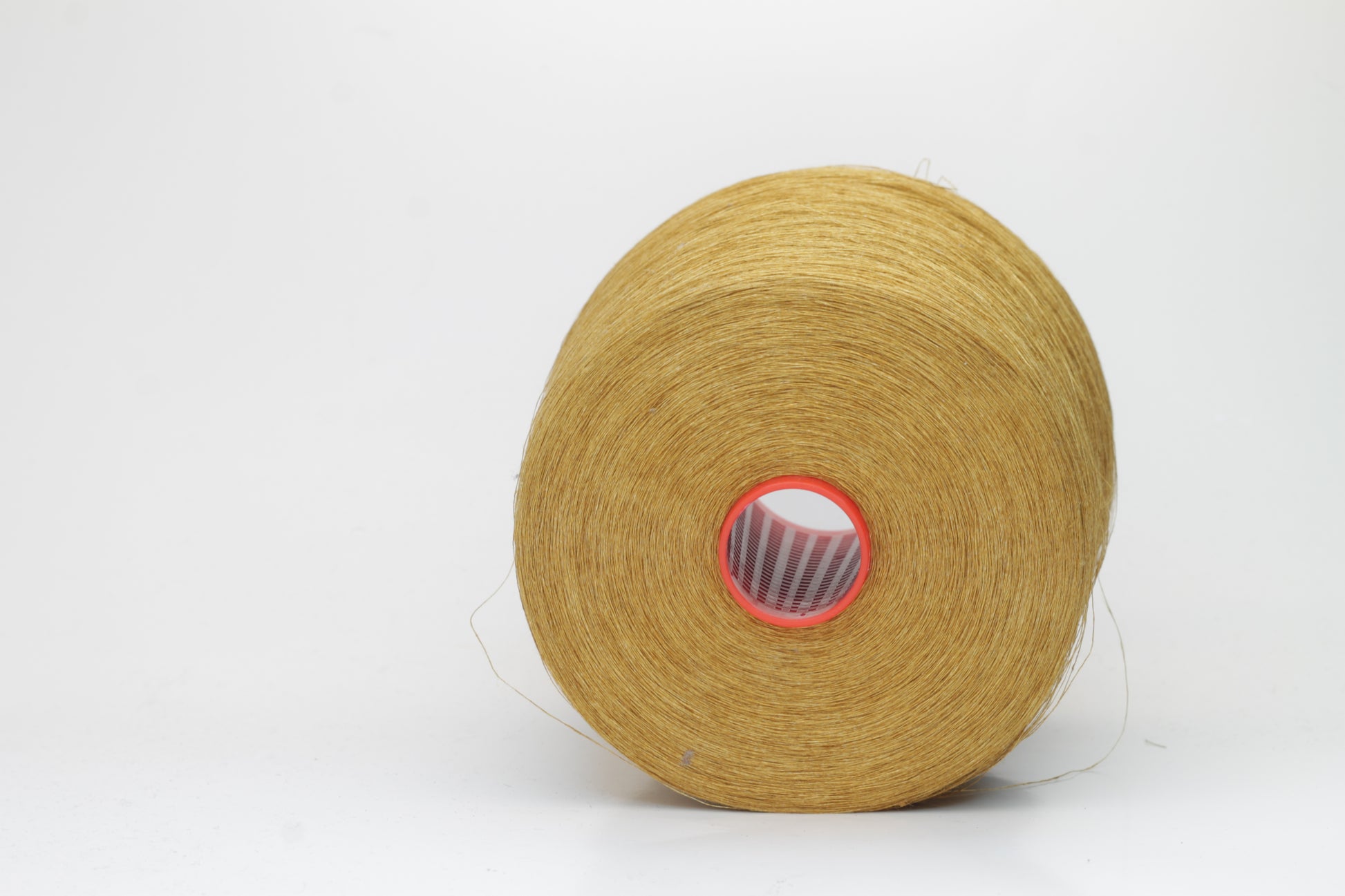 Fine, single-ply linen yarn in a rich Muted Mustard. Reveals a crisp texture and subtle natural sheen, typical of pure linen fiber.