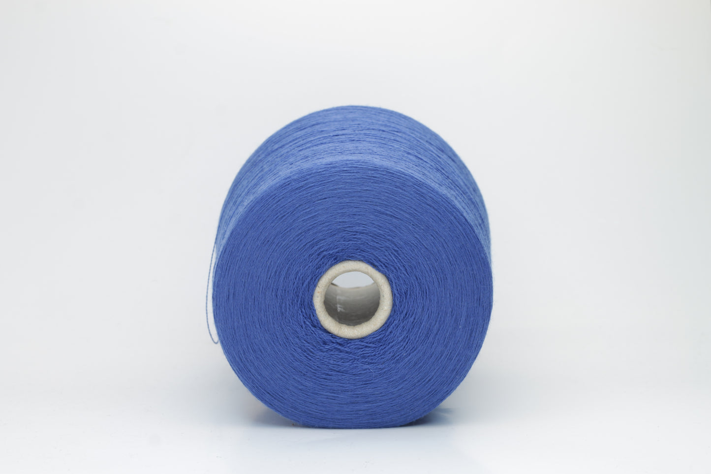 Close-up of luxurious petrol blue Merino wool yarn, two-ply twist with a soft, subtle sheen, and fine, consistent thread structure.