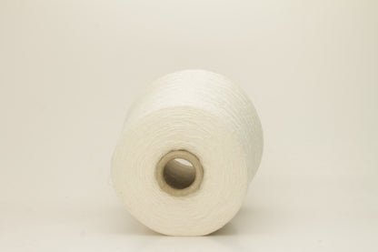 A tightly twisted single strand of luxurious deep royal blue silk yarn, reflecting light with a soft, natural sheen.