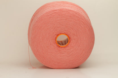 Close-up of soft, two-ply cashmere yarn in a delicate, even pink shade, showcasing its fine, slightly fuzzy texture and subtle sheen.