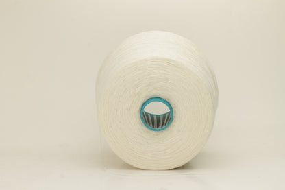 Close-up of a two-ply fine cashmere yarn, tightly twisted with a subtle matte sheen in a creamy off-white Gesso color.