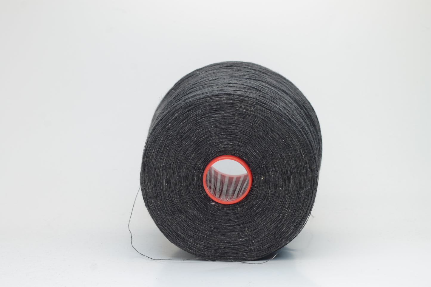 Fine, single-ply linen yarn in a rich Charcoal Black. Reveals a crisp texture and subtle natural sheen, typical of pure linen fiber.