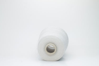 Close-up of lustrous beige 2-ply alpaca merino yarn, subtly twisted with a fine, even structure and soft, low halo.