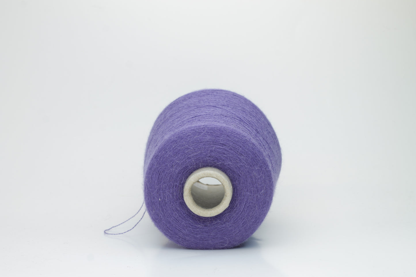 Rich purple 2-ply Alpaca Merino yarn, softly twisted with a gentle halo and subtle sheen, showcasing its deep, luxurious color saturation.