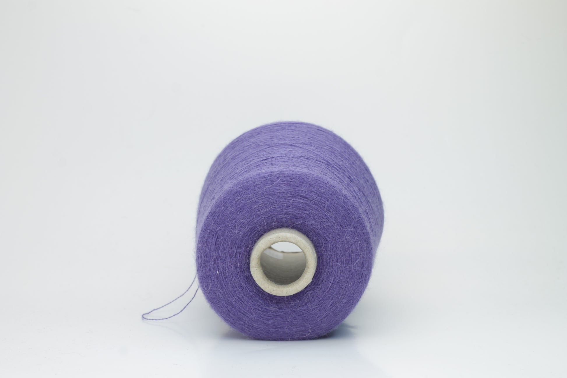 Rich purple 2-ply Alpaca Merino yarn, softly twisted with a gentle halo and subtle sheen, showcasing its deep, luxurious color saturation.