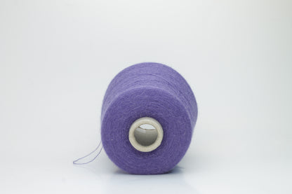 Rich purple 2-ply Alpaca Merino yarn, softly twisted with a gentle halo and subtle sheen, showcasing its deep, luxurious color saturation.