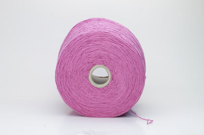 Close-up shot of the Rosa Fuxia Silk Bourette yarn, showcasing its shimmering, fluffy texture and tightly twisted ply structure. The silk fibers exhibit a subtle sheen with rich color depth.