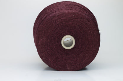 Close-up of a neatly wound cone of deep wine-red 2-ply linen yarn, exhibiting a subtle natural sheen and distinct crisp texture.