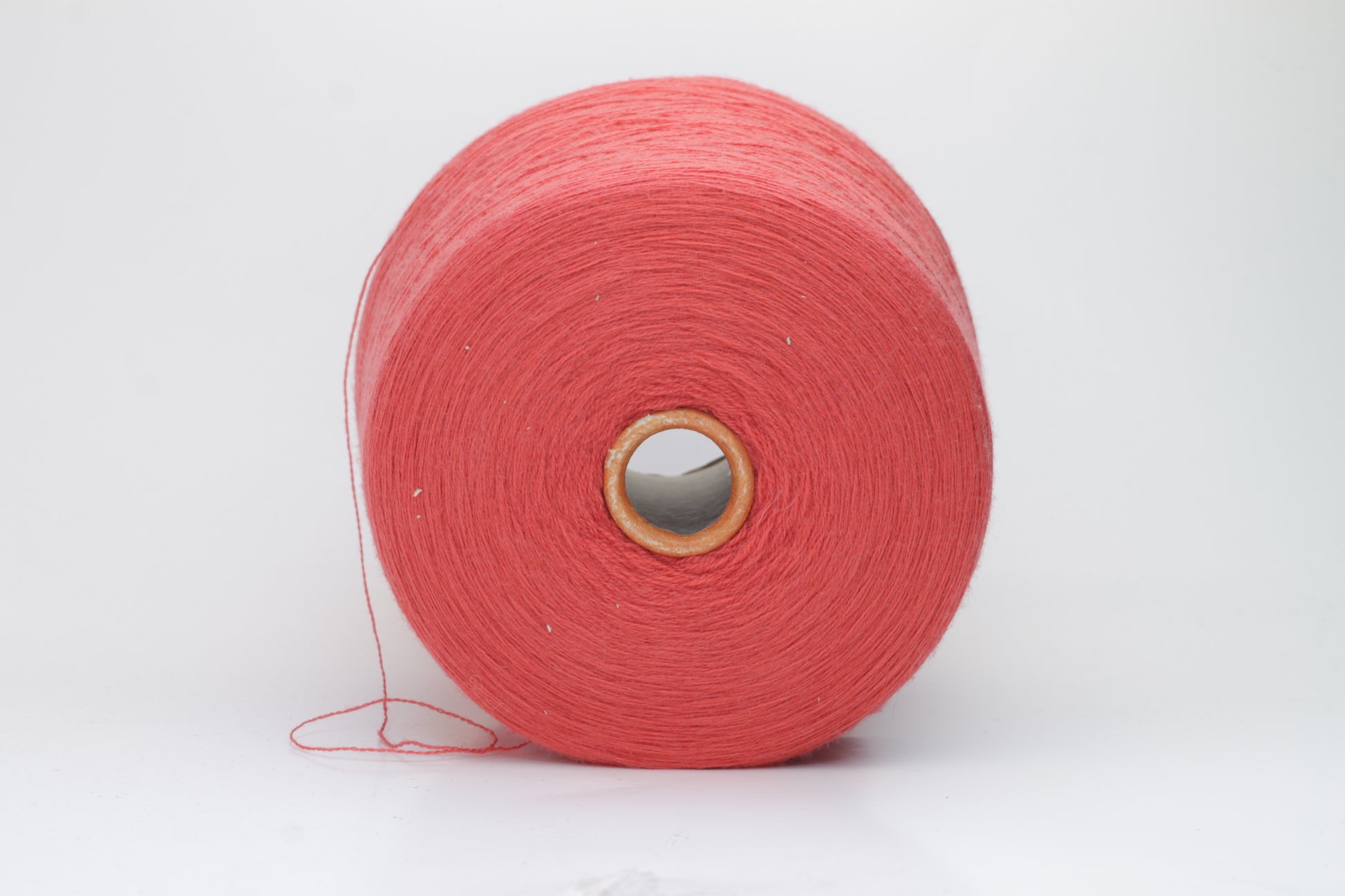 Close-up shot of vibrant red Zegna Baruffa Merino 100% Cashwool yarn, showcasing a tight 2/30 Nm ply twist and rich color depth, highlighting the wool's natural sheen and fluffy texture.