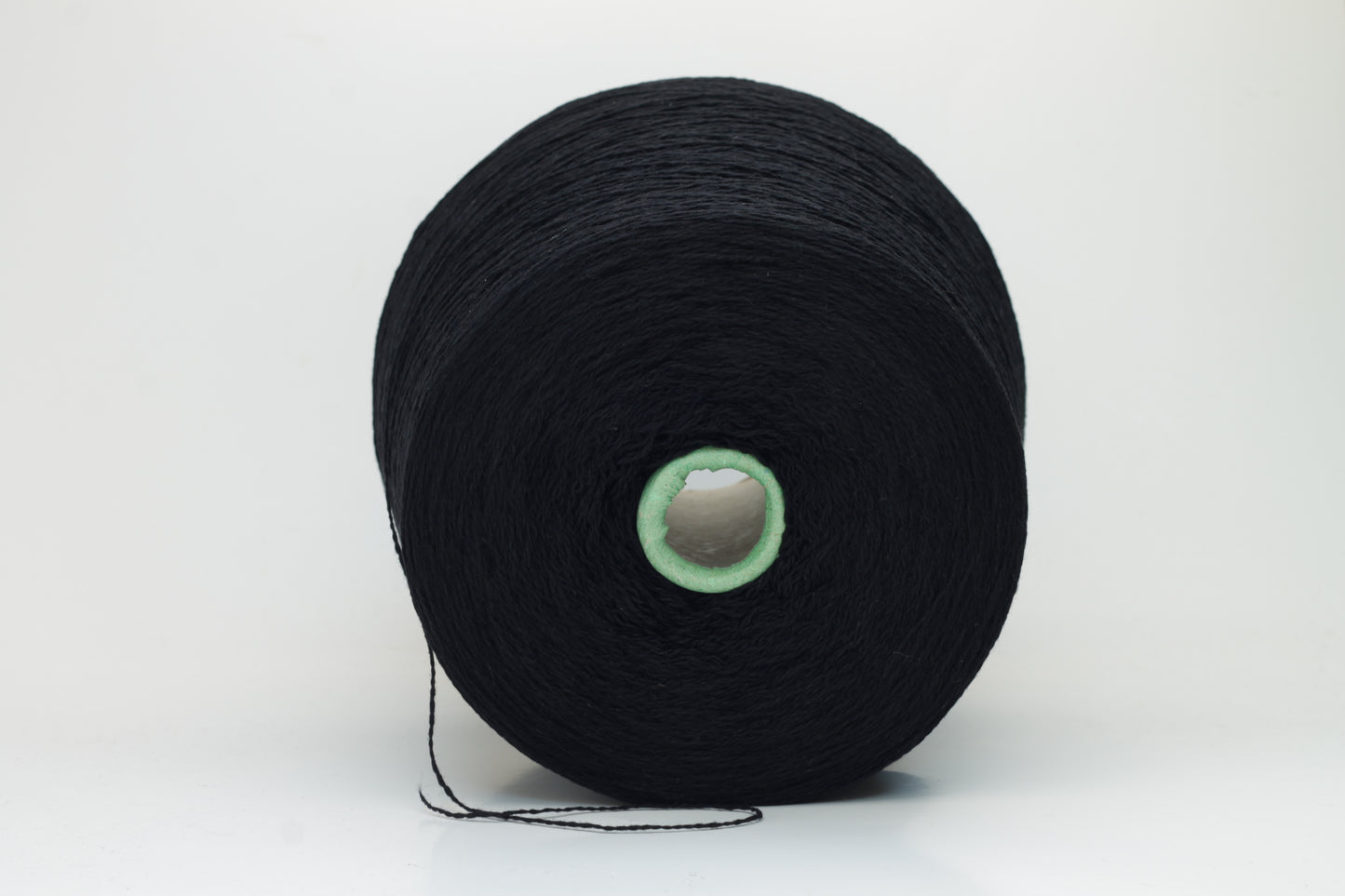 Luxurious black cashmere yarn, two-ply twist with a subtle sheen, displaying deep, consistent color and a fine, soft texture ready for crafting.