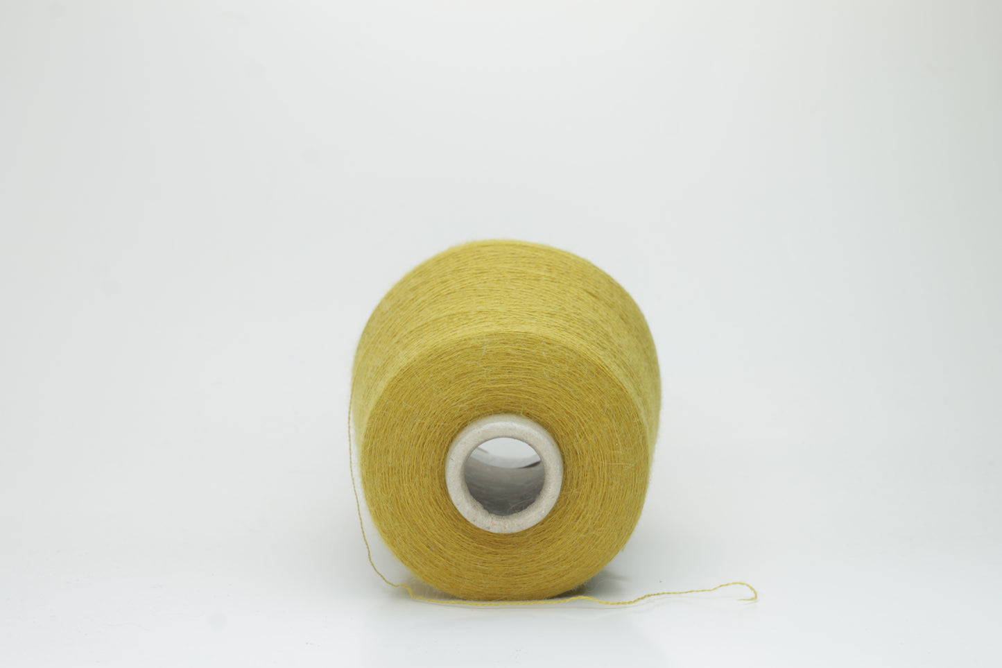Mustard 2-ply Alpaca Merino yarn, softly twisted with a gentle halo and subtle sheen, showcasing its deep, luxurious color saturation.