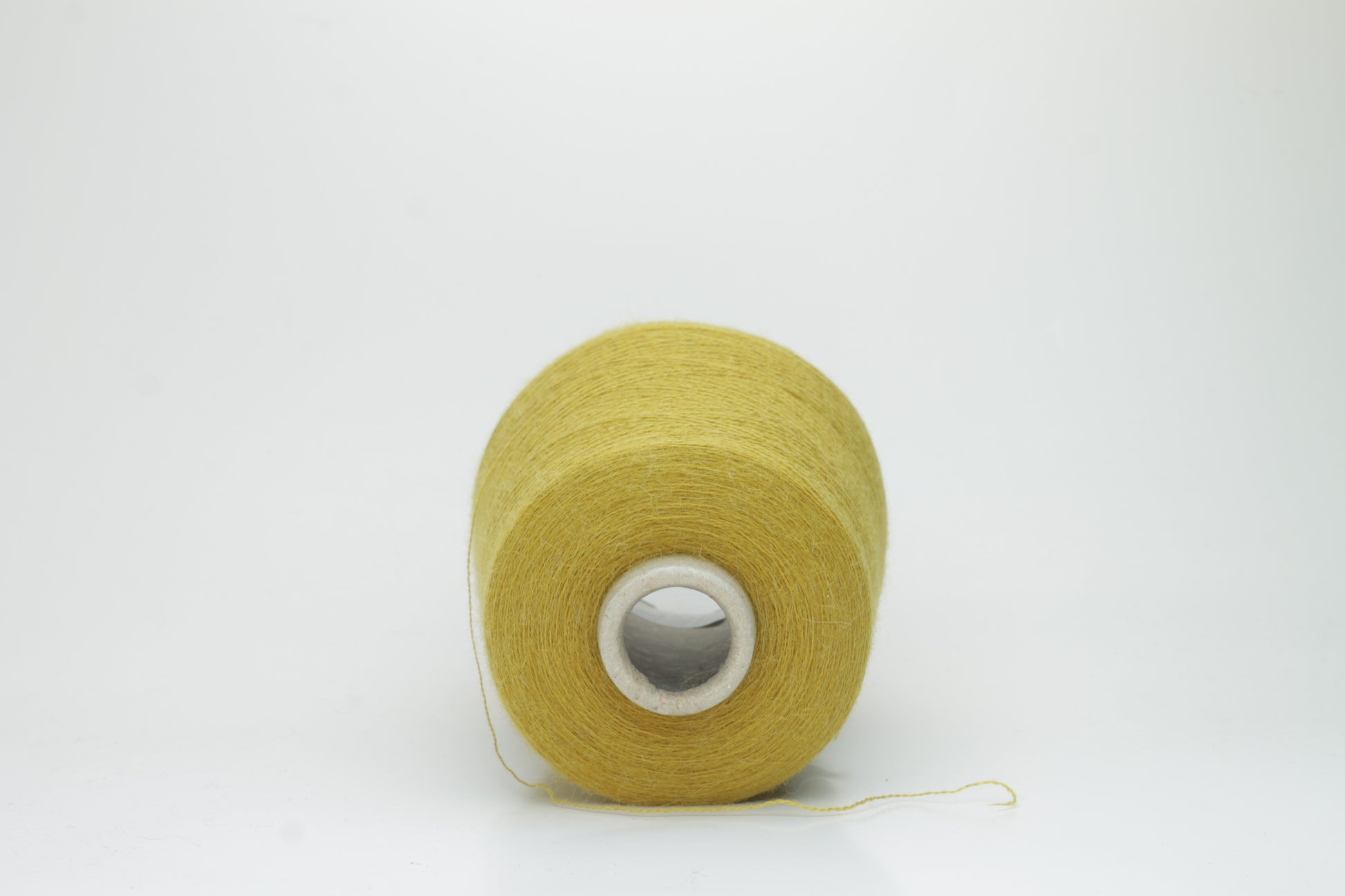 Mustard 2-ply Alpaca Merino yarn, softly twisted with a gentle halo and subtle sheen, showcasing its deep, luxurious color saturation.
