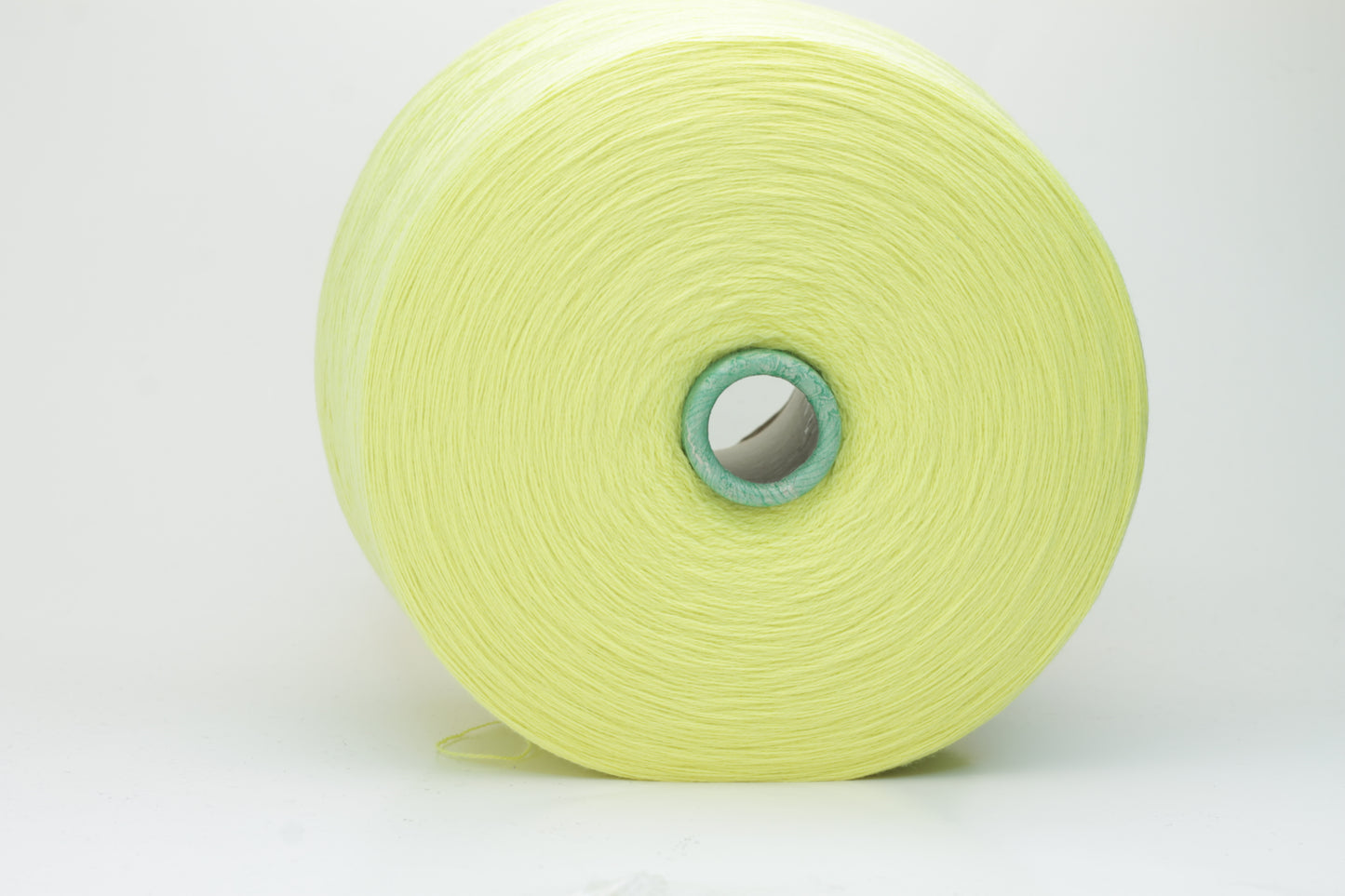 Close-up shot of a skein of ZEGNA Baruffa Merino 100% Cashwool yarn in Lemon color. The yarn exhibits a tight, twisted ply structure with a subtle sheen and a fluffy, inviting texture.