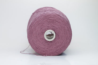 Close-up image of the burgundy silk bourette yarn, showcasing a dense ply twist and subtle sheen. The yarn appears incredibly soft and fluffy with rich color depth.