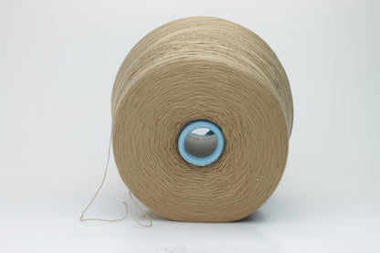 Close-up shot of a cone of creamy camel colored 100% merino yarn, showcasing the fine ply twist and subtle sheen of the fibers.