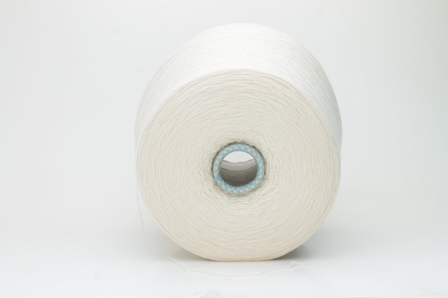 Close-up of a finely spun, 2-ply cashmere yarn skein in a delicate, warm champagne beige. Features a soft, subtle napped texture and elegant sheen.