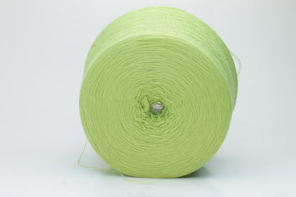 Close-up shot of the '100% Merino Toolegno 1900 Nm 2/30 Green Premium Yarn', showcasing the fluffy green fibers and a prominent ply twist, highlighting the dense thread structure and subtle sheen.