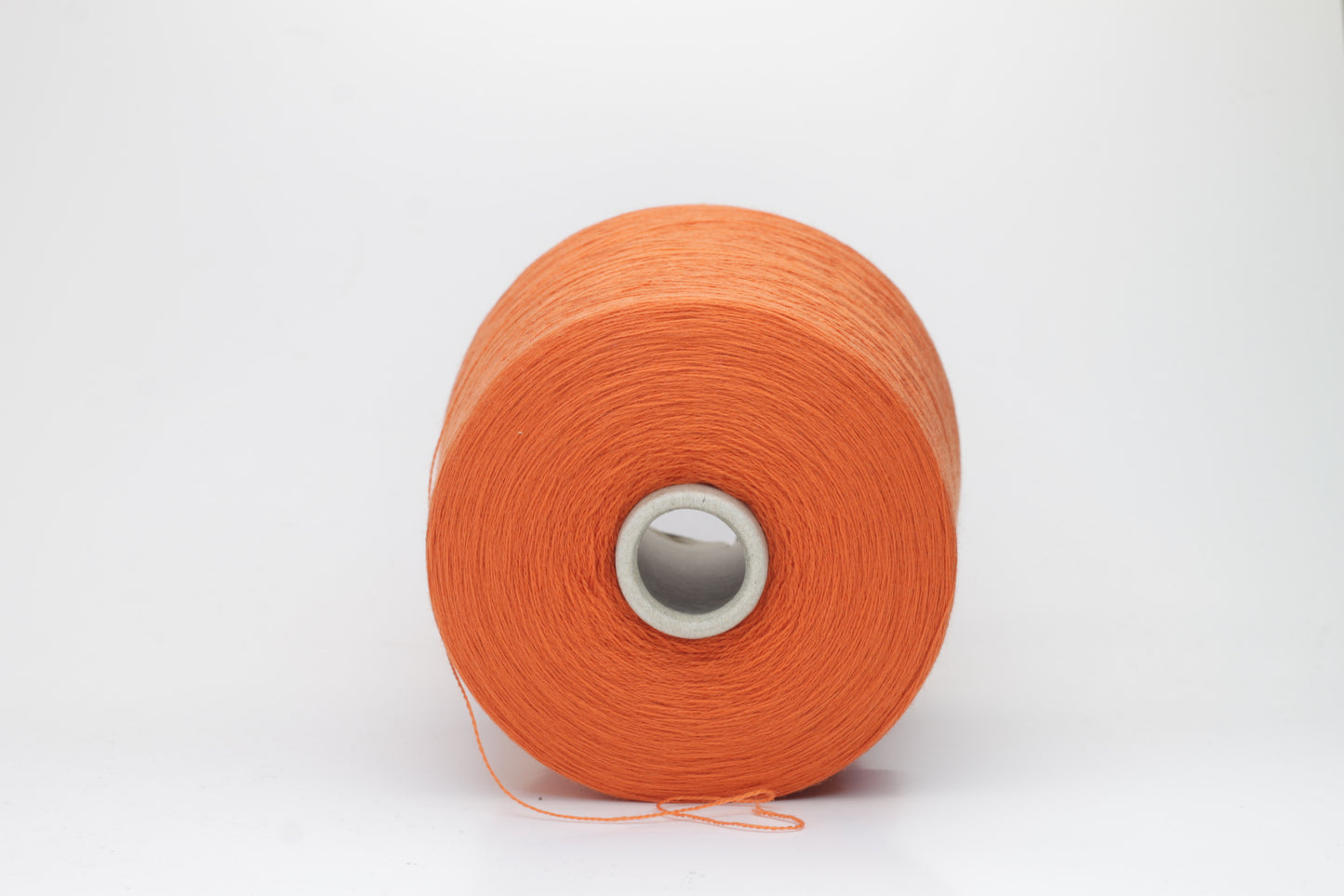 Close-up of luxurious Cognac Merino wool yarn, two-ply twist with a soft, subtle sheen, and fine, consistent thread structure.