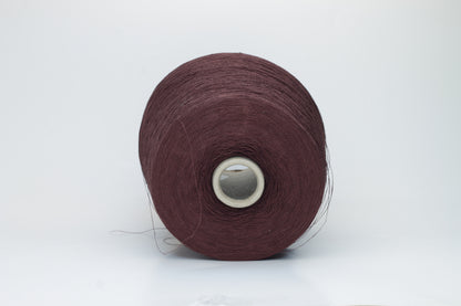 Close-up of a tightly twisted, fine-gauge yarn in a deep, warm earthy brown color, showing a subtle natural sheen from the linen fibers.