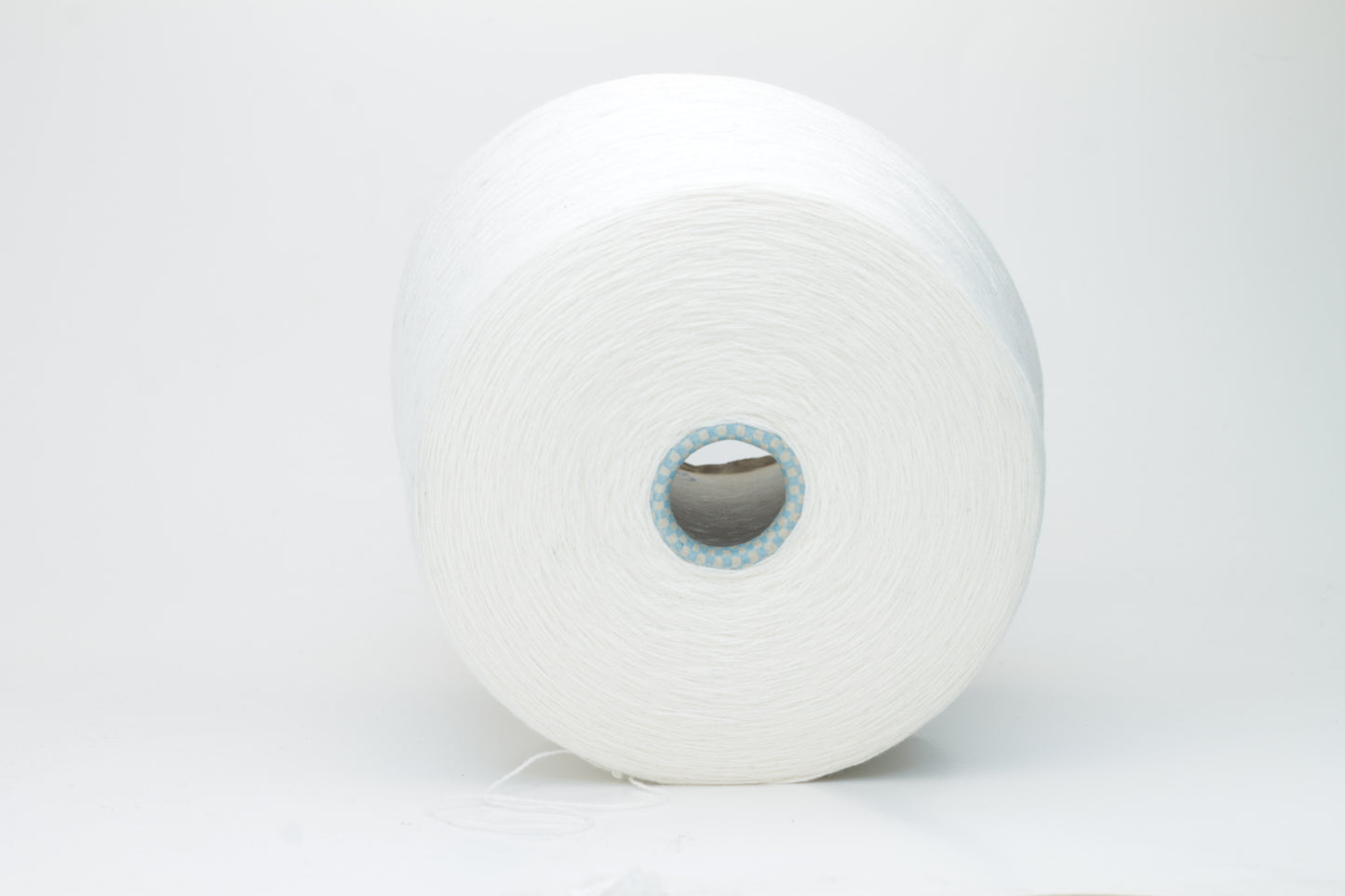 Close-up of a luxurious, soft skein of pale, milky blue cashmere yarn with a subtle sheen and light, even two-ply twist.