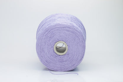 Close-up of a single strand of matte lavender silk bourette yarn, showcasing its natural slub texture and soft, nubbly appearance, coiled gently.