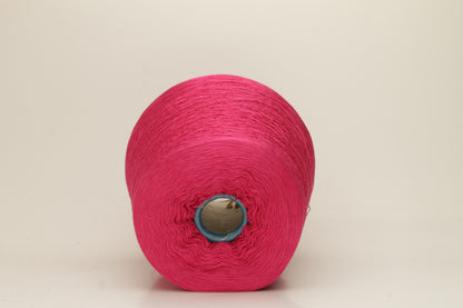 Close-up of vibrant hot pink 100% pure silk yarn, showcasing its fine, smooth single ply and high, natural luster reflecting light beautifully.
