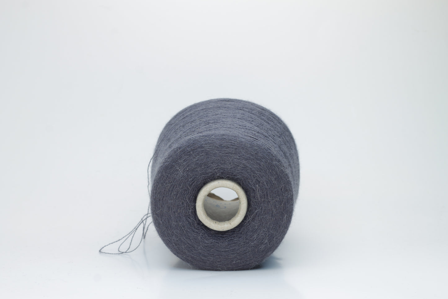 Rich Gray 2-ply Alpaca Merino yarn, softly twisted with a gentle halo and subtle sheen, showcasing its deep, luxurious color saturation.