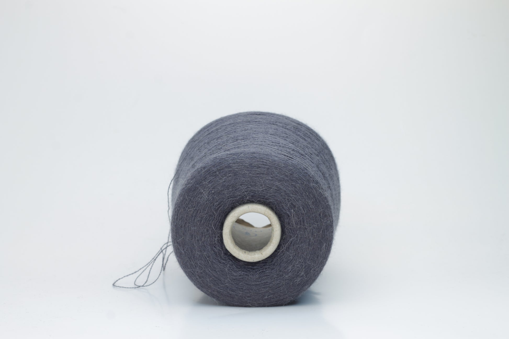 Rich Gray 2-ply Alpaca Merino yarn, softly twisted with a gentle halo and subtle sheen, showcasing its deep, luxurious color saturation.