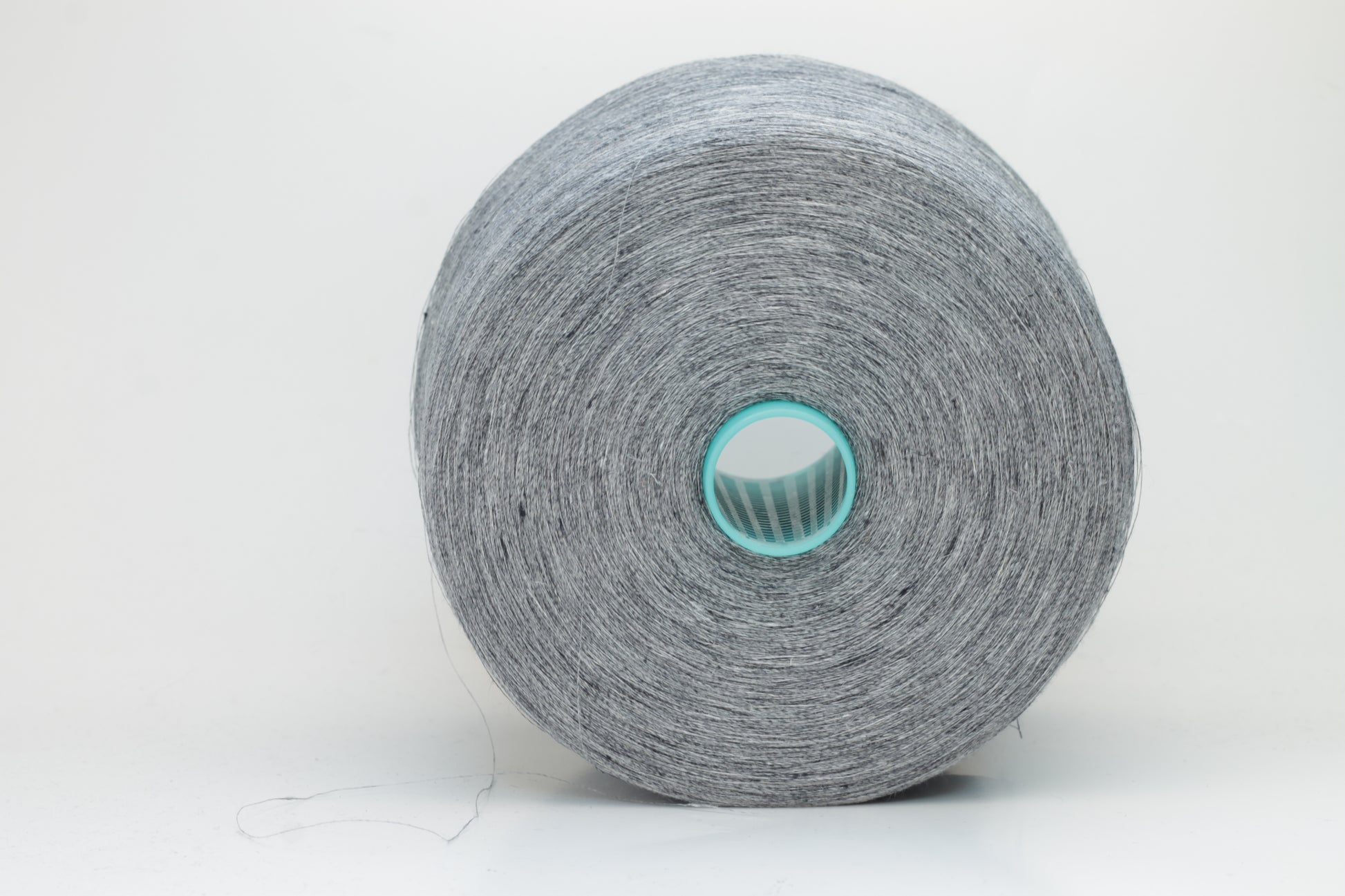 Fine, single-ply linen yarn in a rich Slate Blue-Gray. Reveals a crisp texture and subtle natural sheen, typical of pure linen fiber.