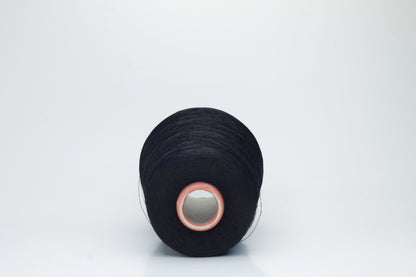 A single, tightly spun strand of incredibly fine, jet black silk yarn, showcasing a brilliant, almost glass-like sheen.