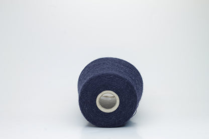 Close-up of Quipa Nm 2/28 Alpaca Merino yarn, showing its soft, slightly diffused fibers and a tight, even two-ply twist in a rich, dark navy hue.