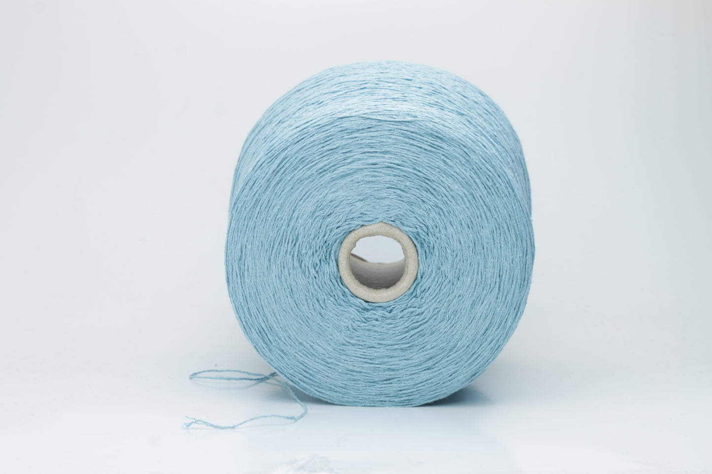Close-up shot showcasing the shimmering, fluffy texture of the Coscata Silk Bourette yarn, with visible ply twists and a subtle sheen, highlighting its luxurious feel.