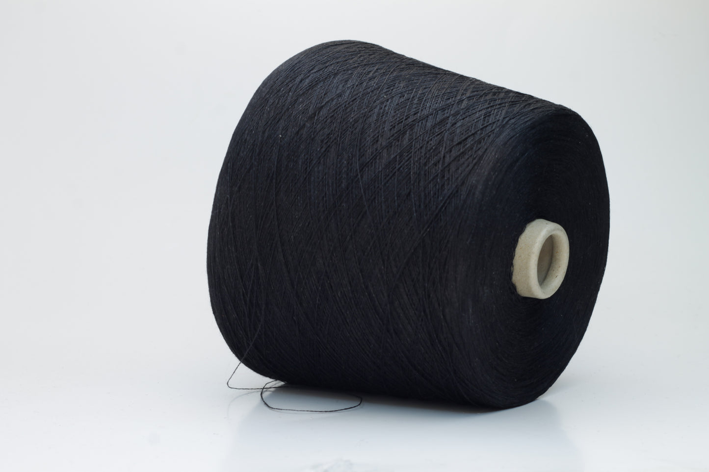 Finely spun Nm 2/26 linen yarn in a rich, deep ardesia slate gray, showcasing a smooth, uniform twist and subtle natural sheen.
