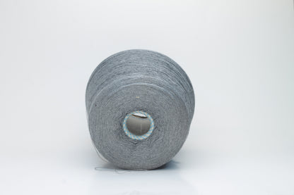 Close-up of a meticulously twisted two-ply 100% silk yarn, revealing a subtle, sophisticated medium gray hue with a natural, elegant sheen.