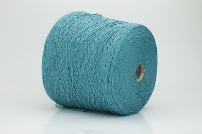 Close-up of a skein of deep petrol blue-green bourette silk yarn, showing its characteristic subtle slubs and matte texture, with a gentle, soft twist.